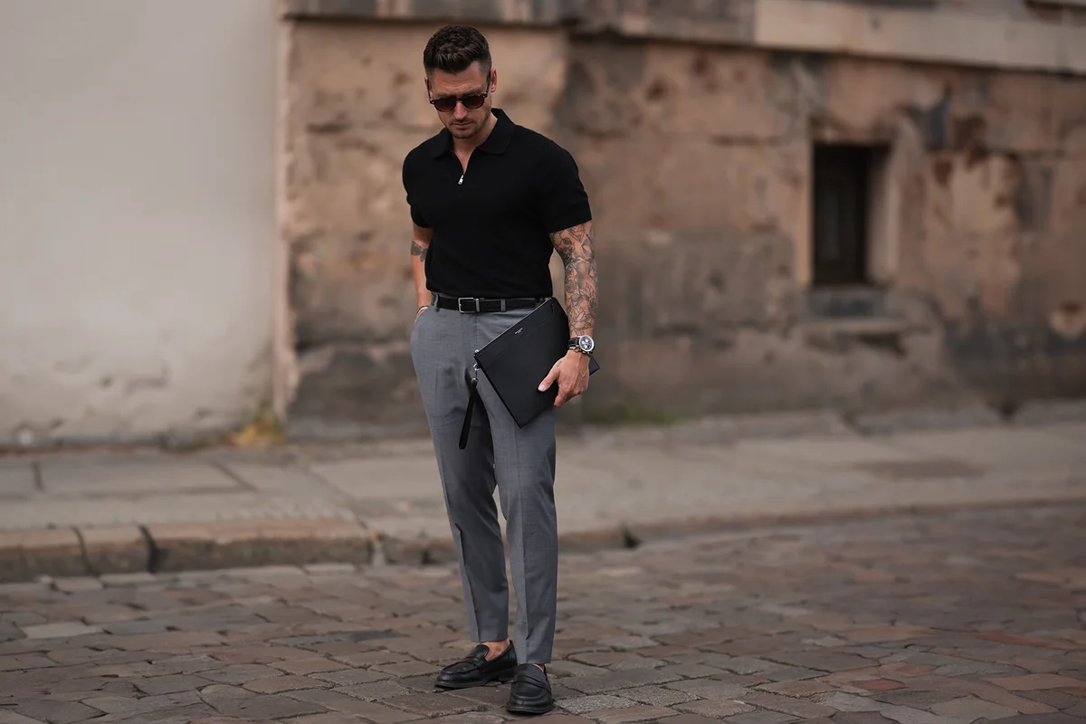 Man wearing grey suit pants and polo shirt