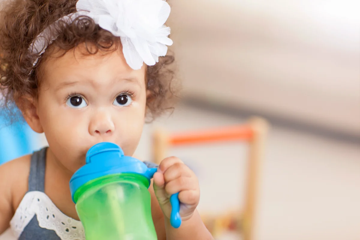 little girl with sippy cup