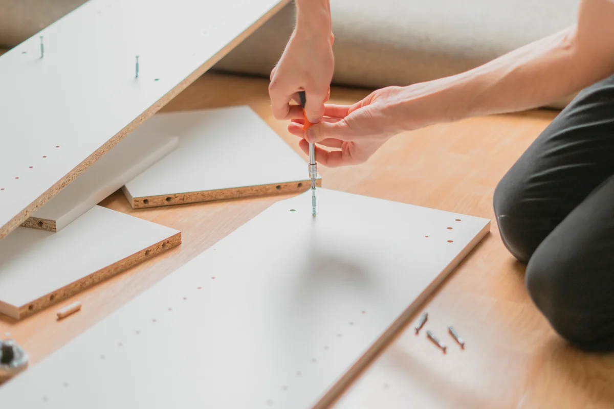 Assembling white particle board furniture