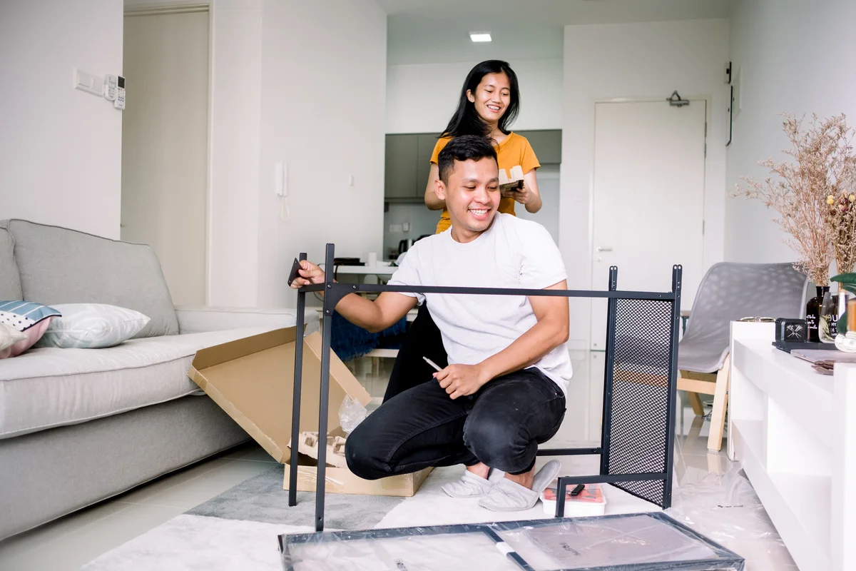 Young couple assembling black table