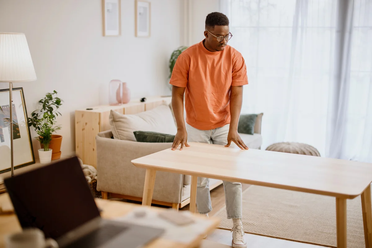 Man assembling wooden Ikea table