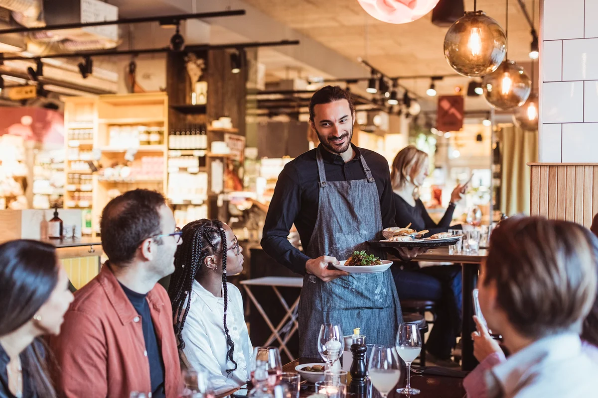Waiter serving food to customers