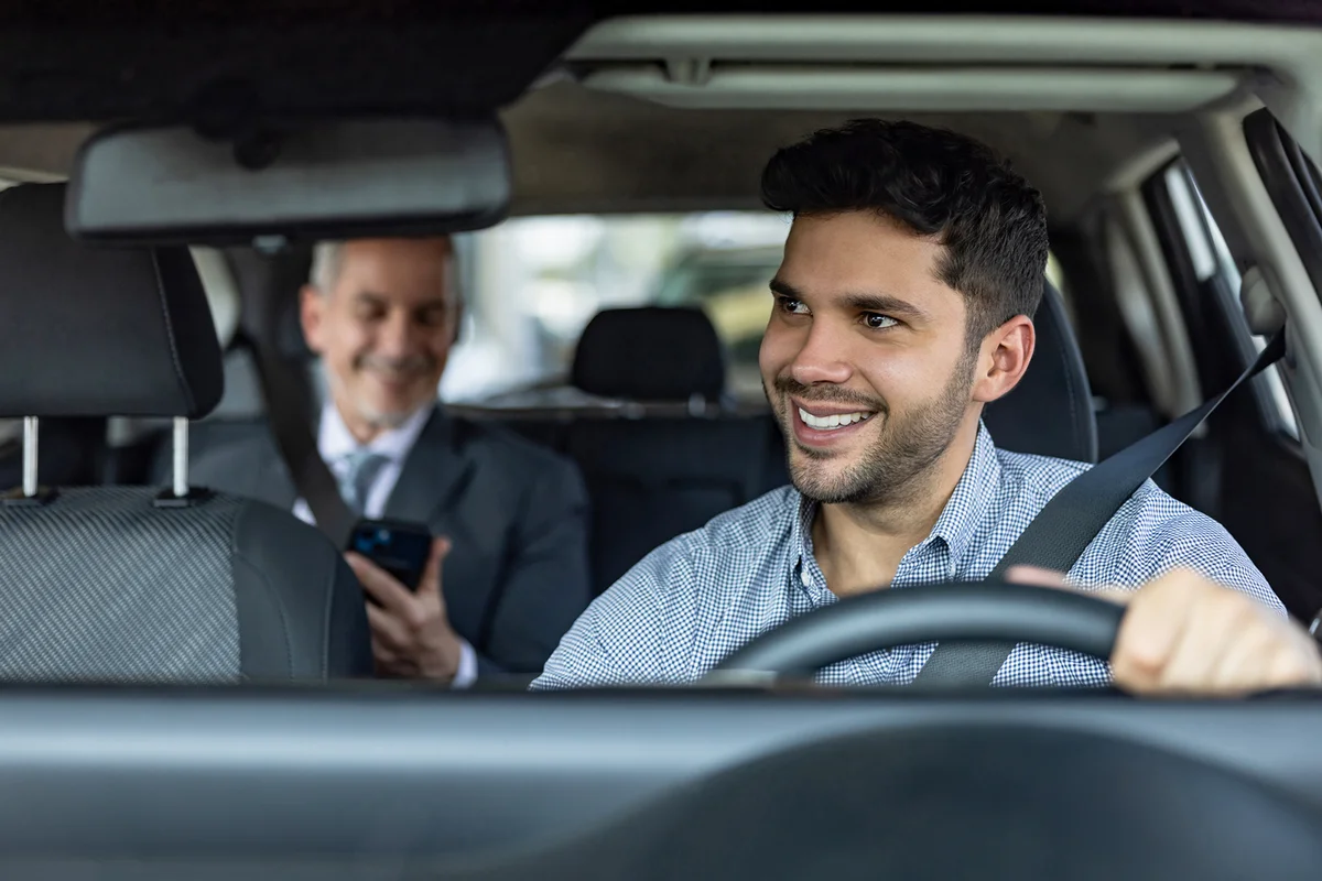 Driver transporting a business man on a crowdsourced taxi