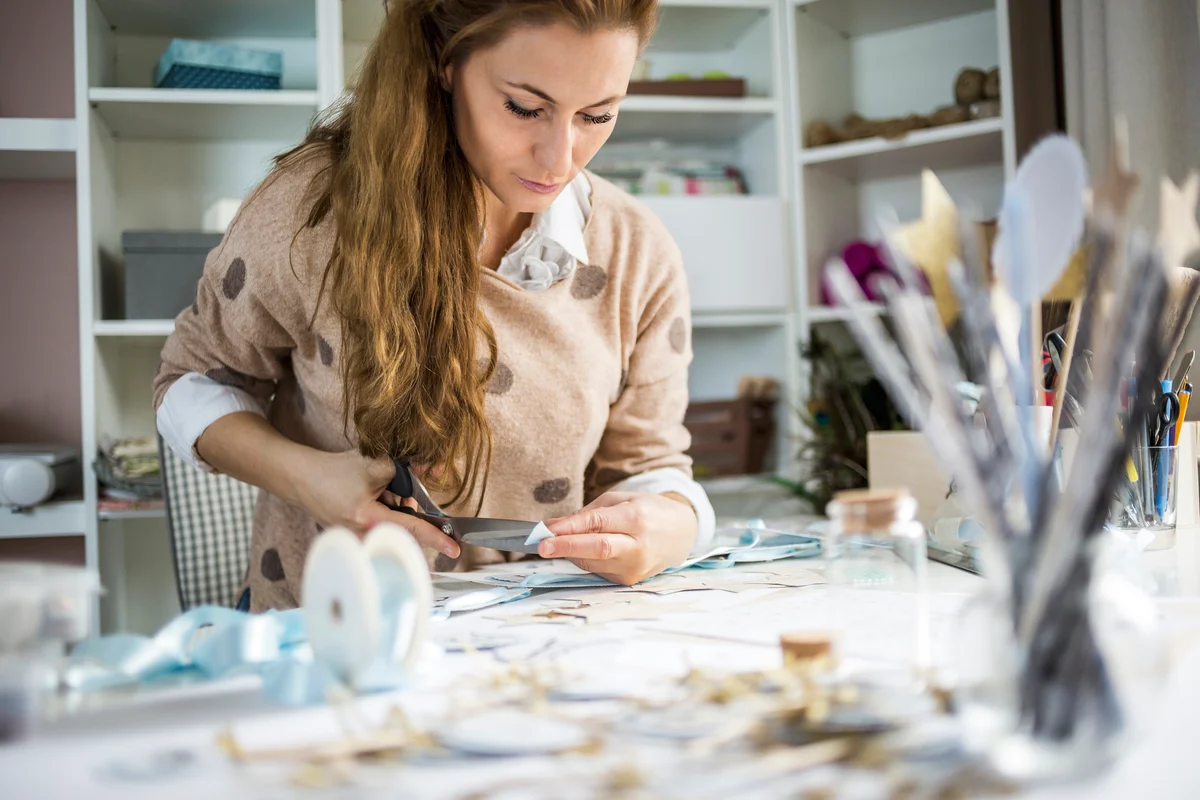 woman creating a scrapbook