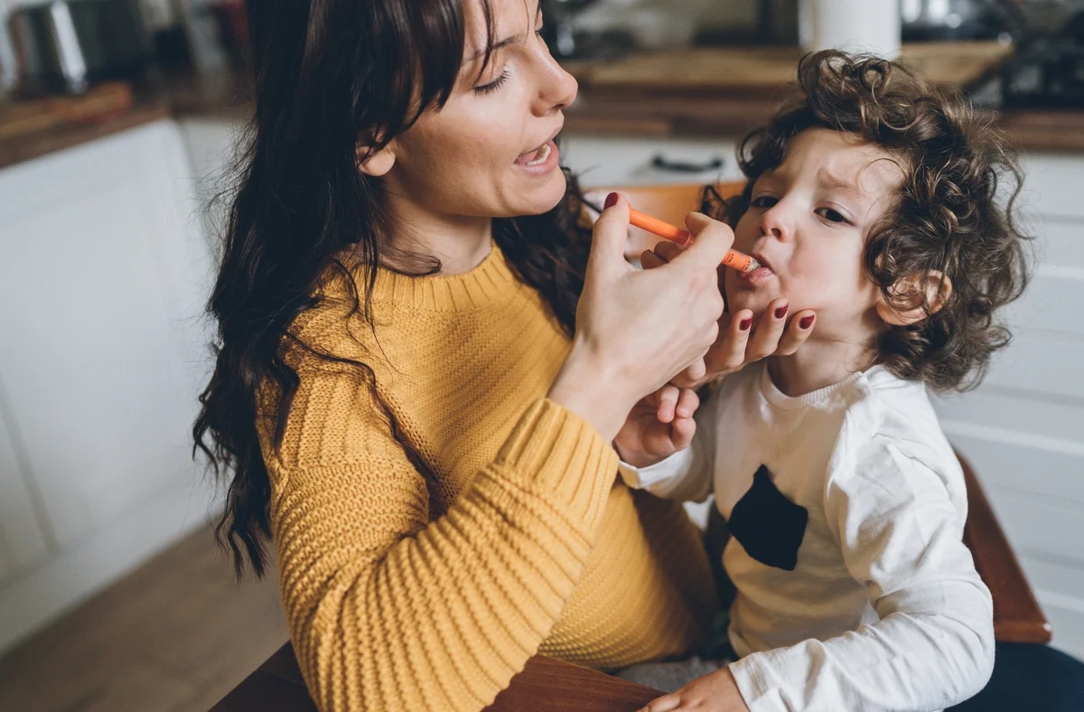 toddler taking medicine