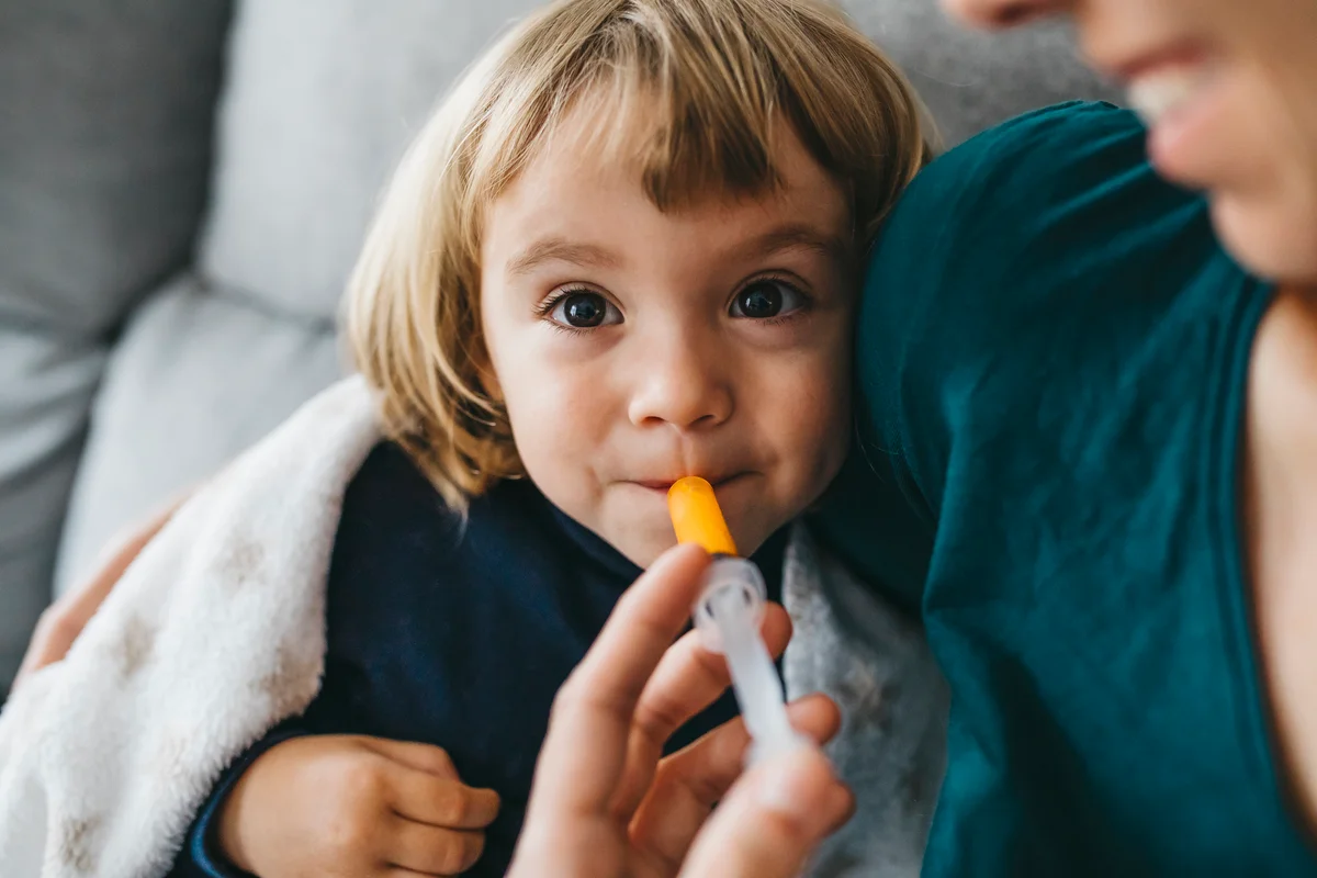 child taking medicine