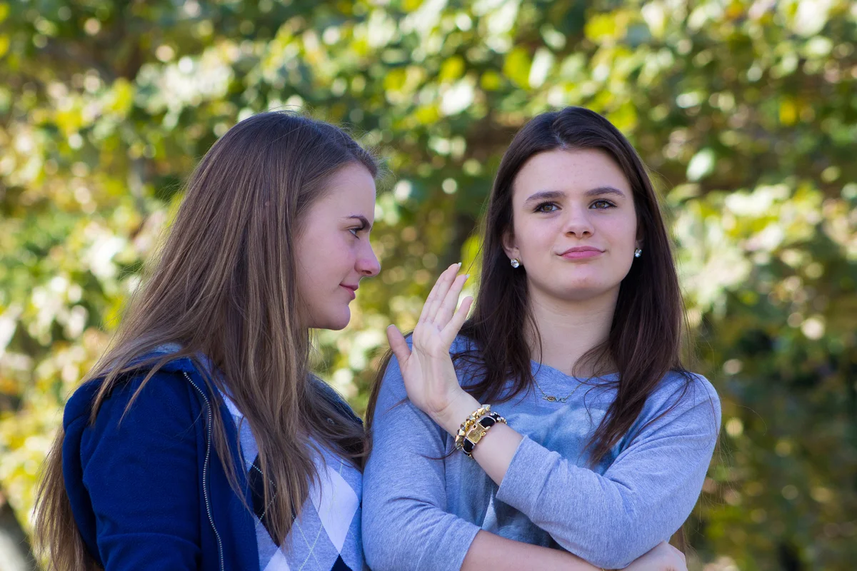 Girl holding up her hand to her sister