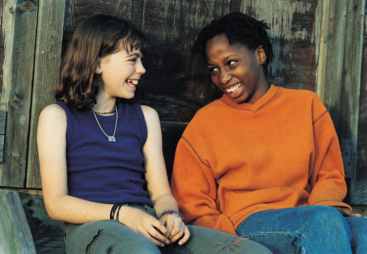 two girls smiling at each other