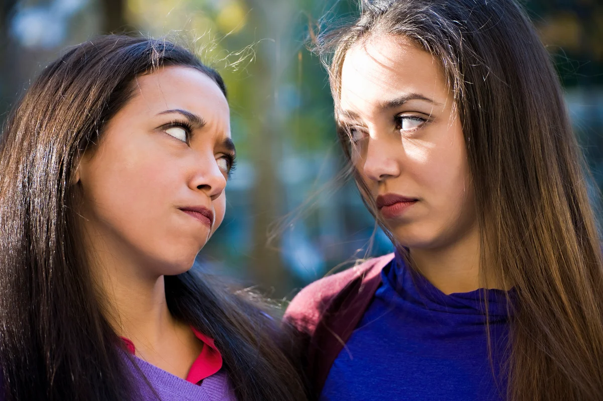 twin sisters glaring at each other