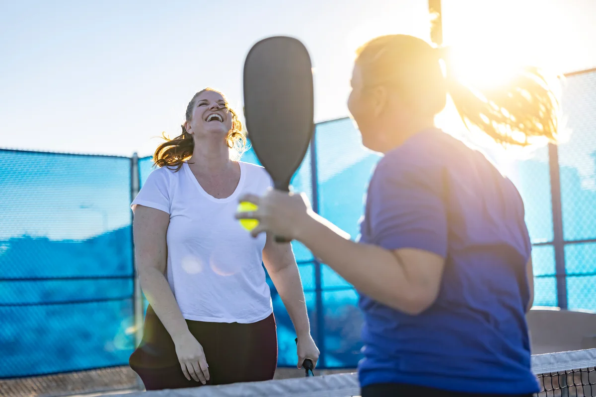 Two women friends having fun at pickleball