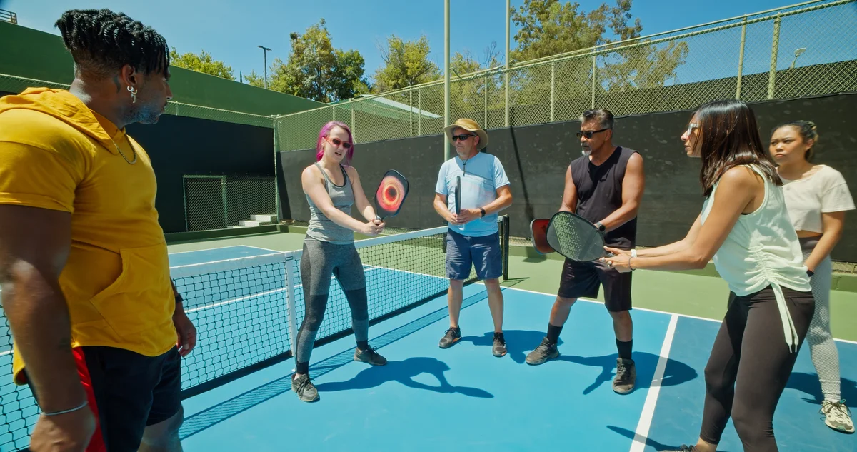 Pickleball instructor teaching group of students
