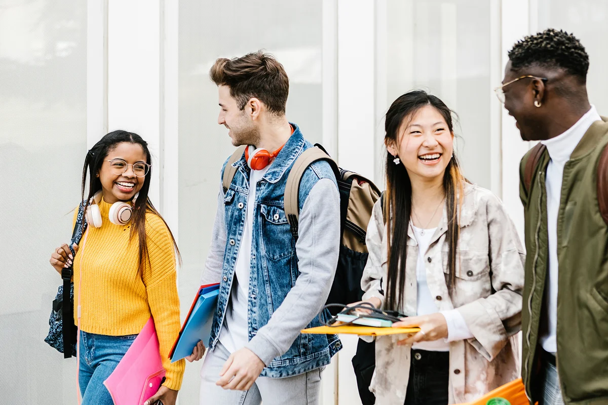 Happy young group of students hanging out