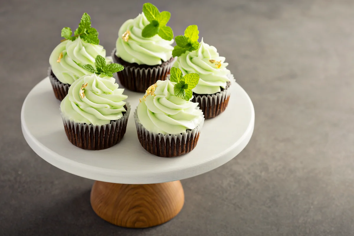 Chocolate mint cupcakes with golden leaf on a cake stand