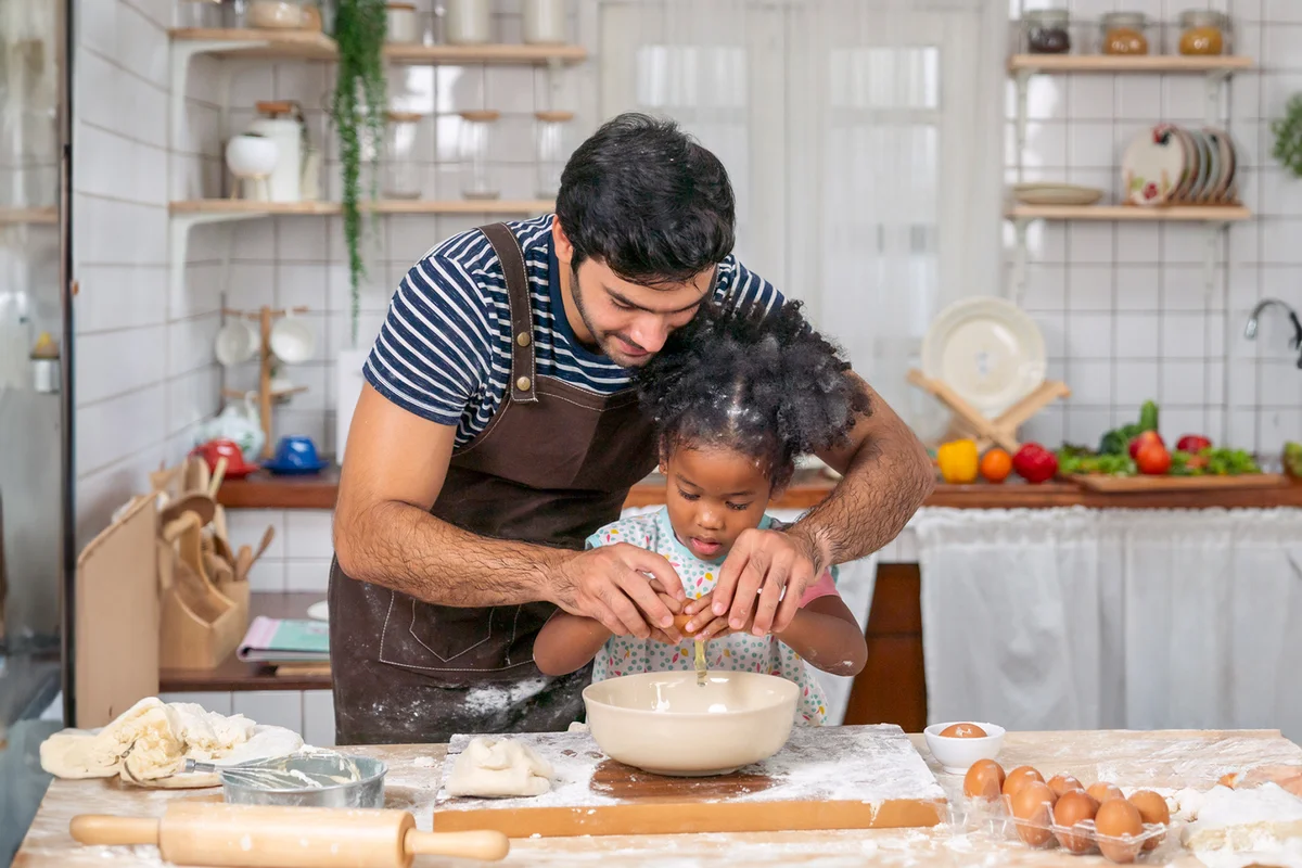 Happy father and daughter in the kitchen