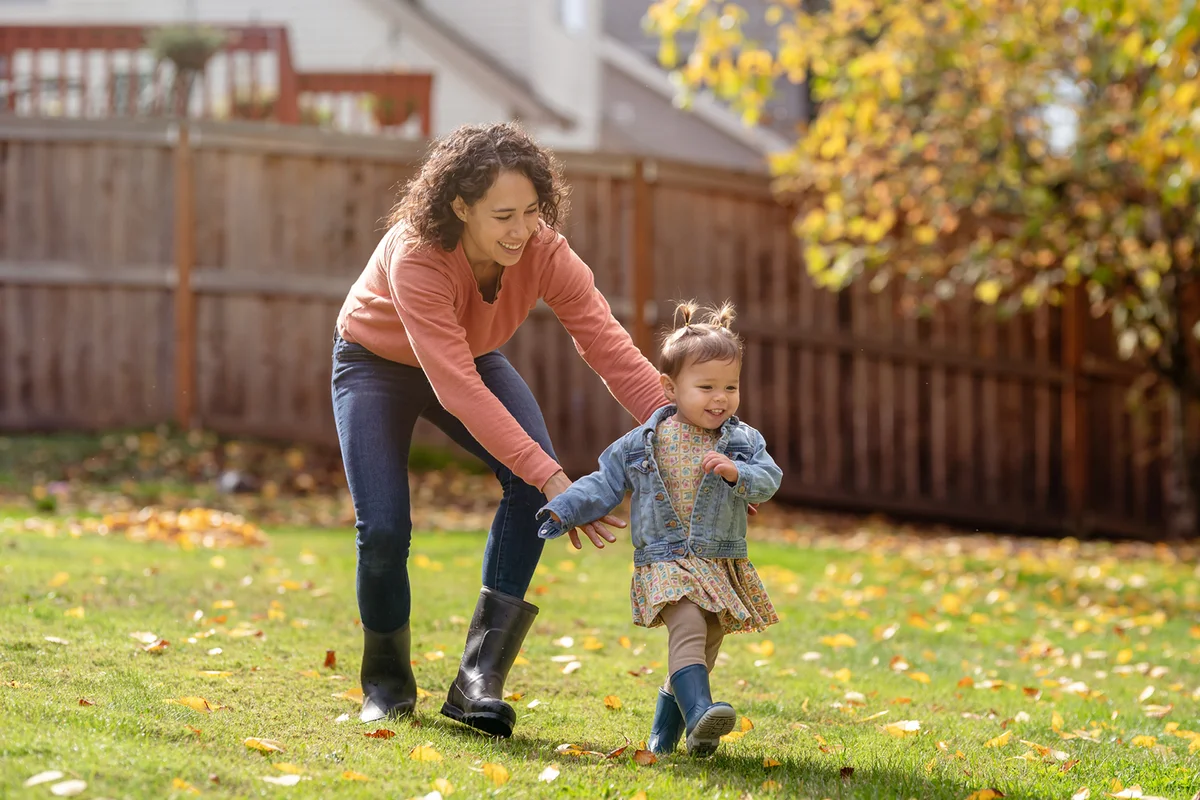 Mom playing outside with her daughter