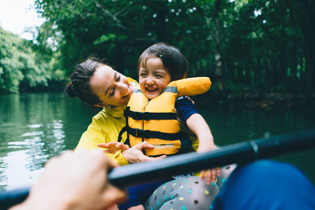 Mother and child having fun with mangrove river kayaking