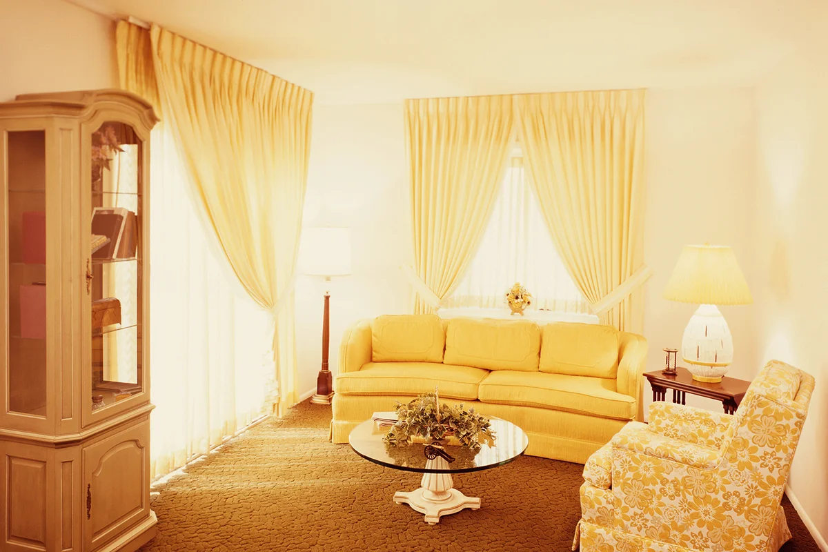 Living room interior, with gold carpet and yellow couc
