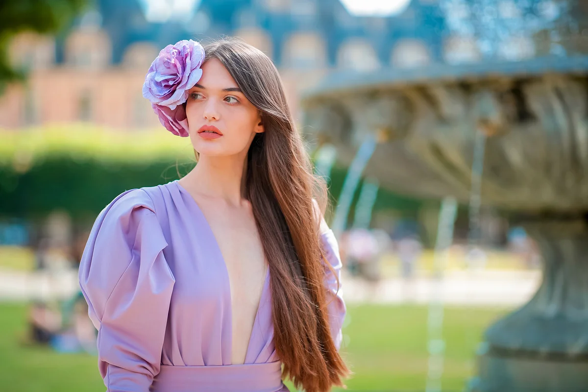 woman in purple dress and flower fascinator