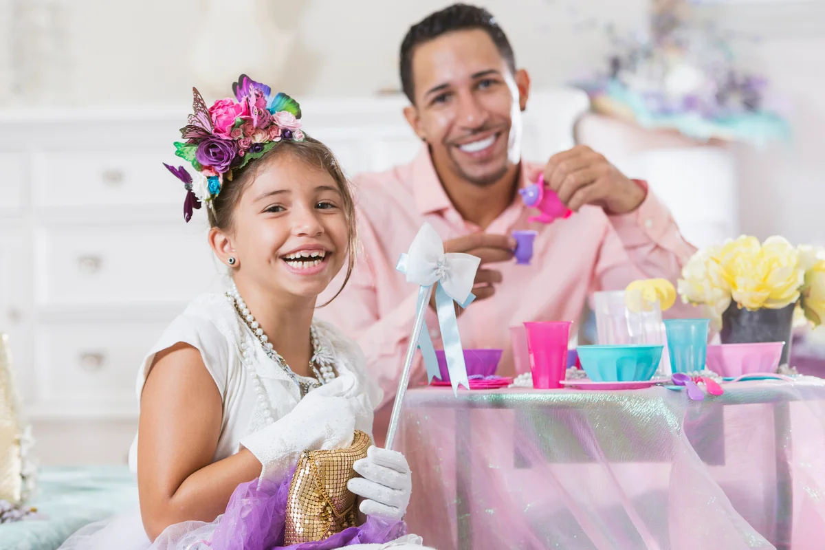 Father and daughter having tea party