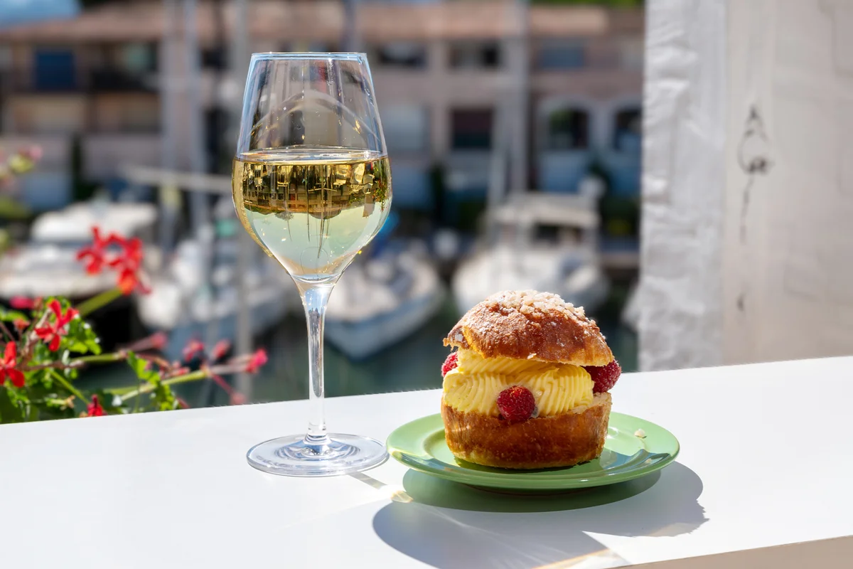 brioche with cream and fresh berries.and glass of white wine