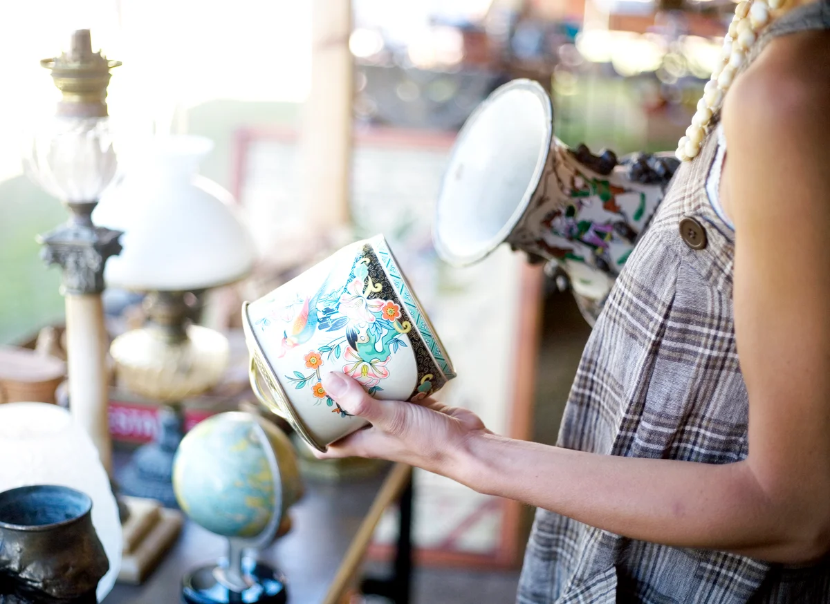 woman looking at an antique object