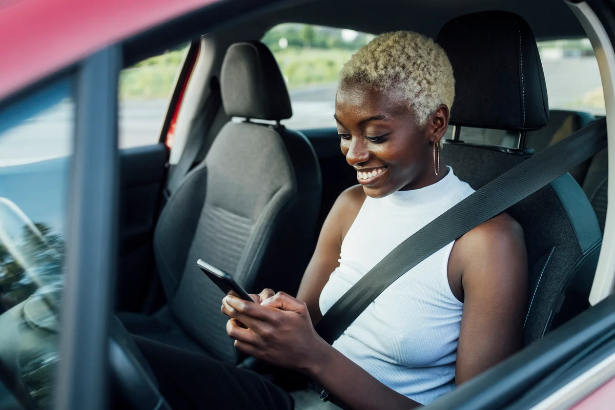 woman in car texting