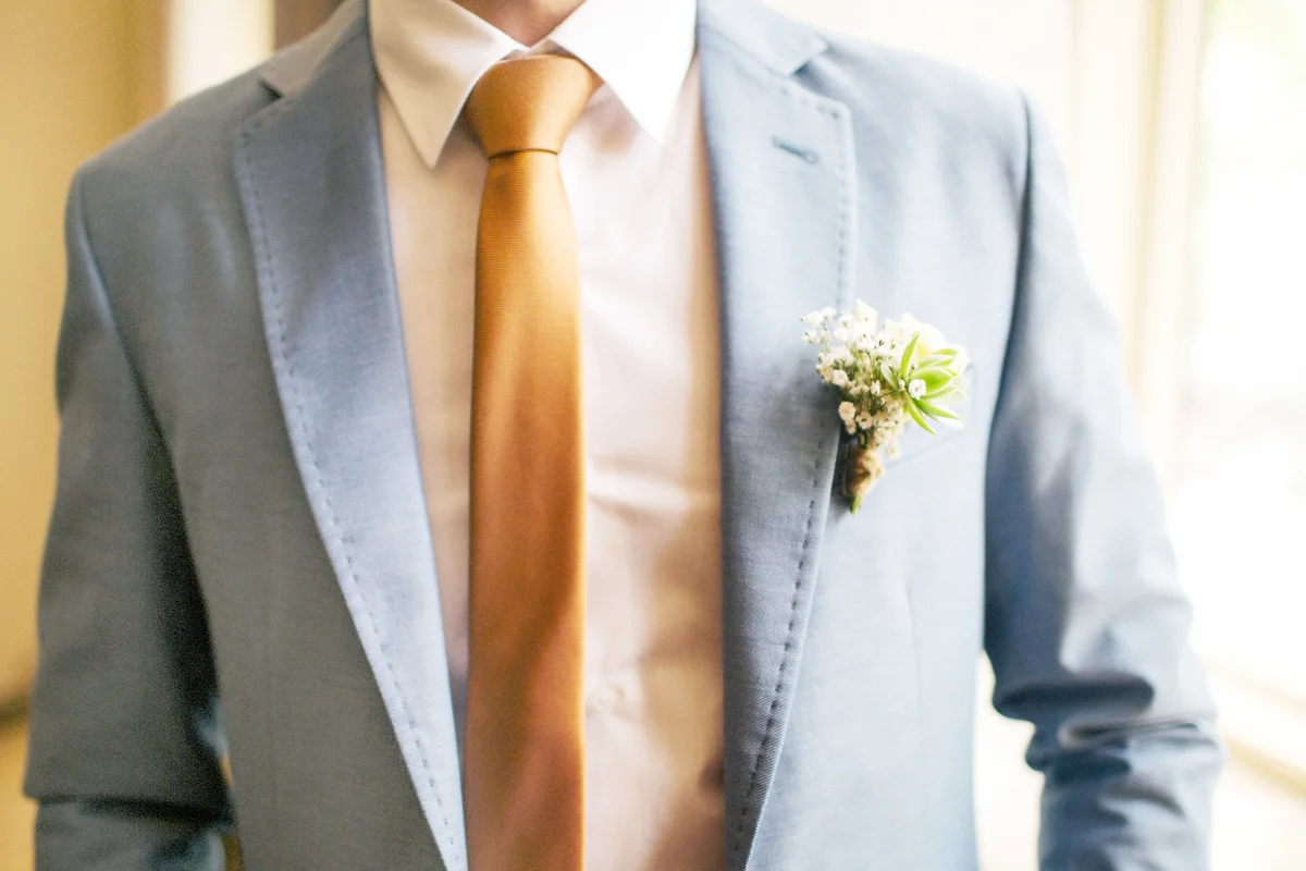 Groom with flower on his blue suit