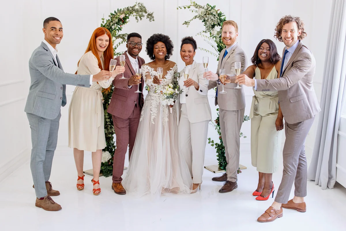 Newlyweds toasting champagne with guests