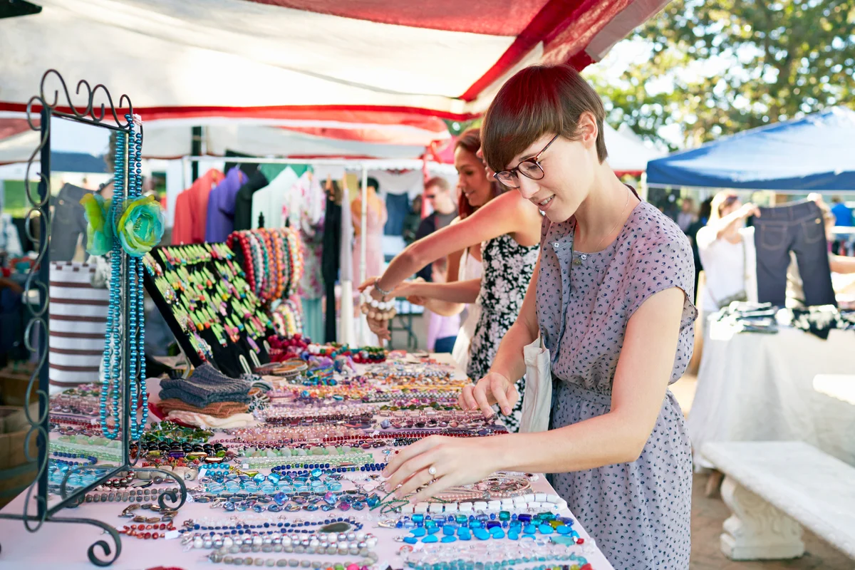 Woman looking at necklaces at a pop-up market