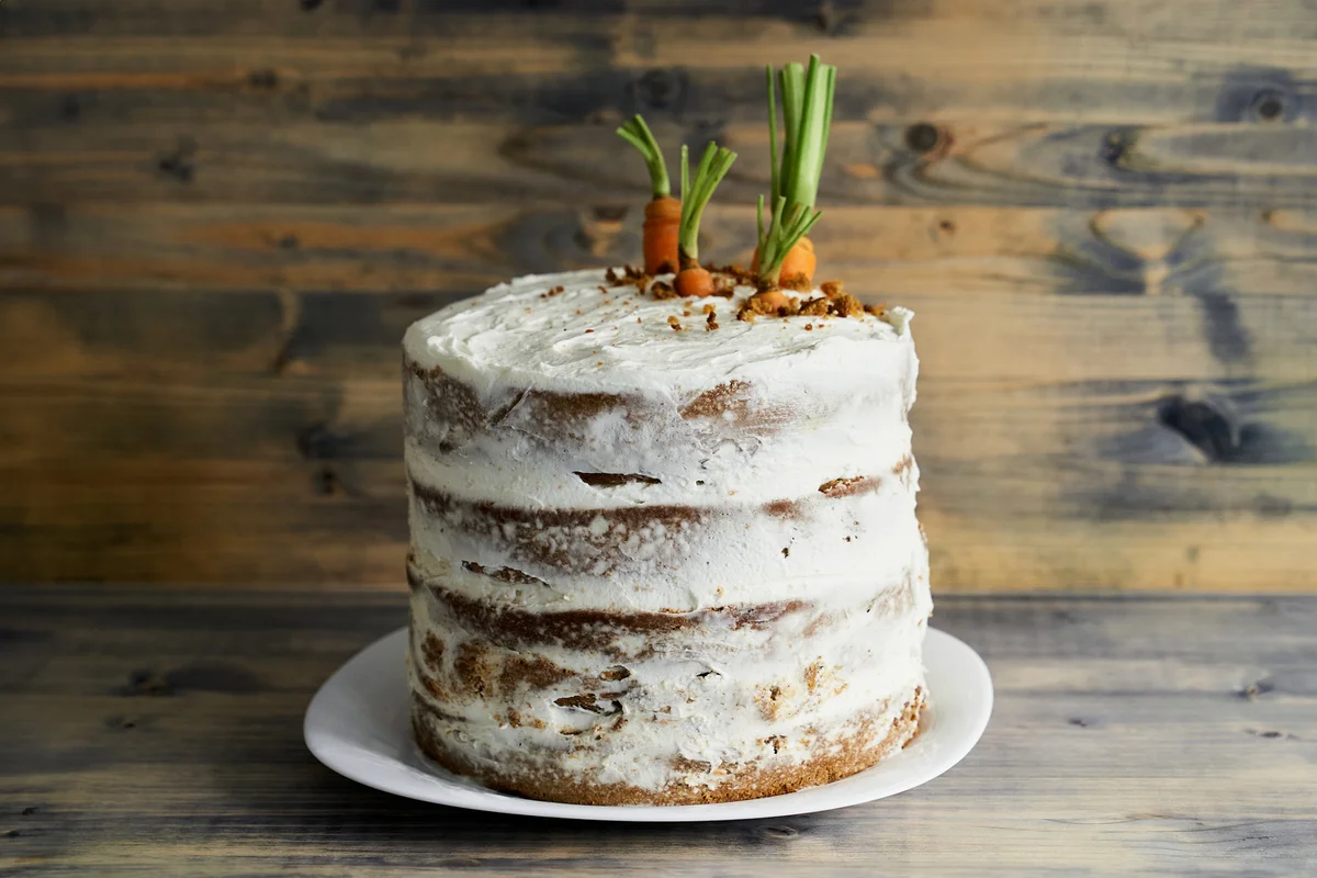 Carrot cake on a plate on wooden background