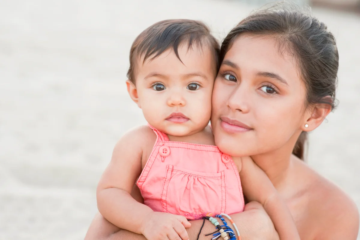 Mother hugging baby girl