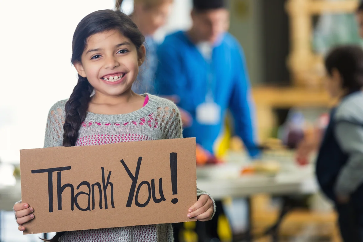 little girl with thank you sign
