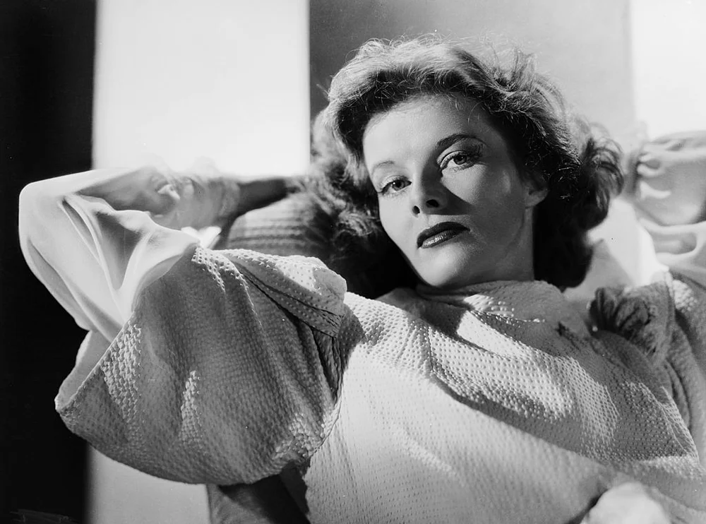 1938: American actress Katharine Hepburn (1907 - 2003) relaxes with her hands behind her head. (Photo by Ernest Bachrach/John Kobal Foundation/Getty Images)