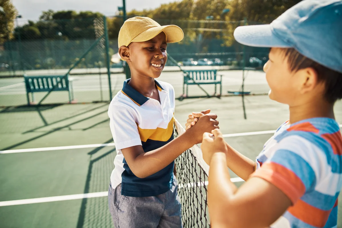 preteens shaking hands after tennis match