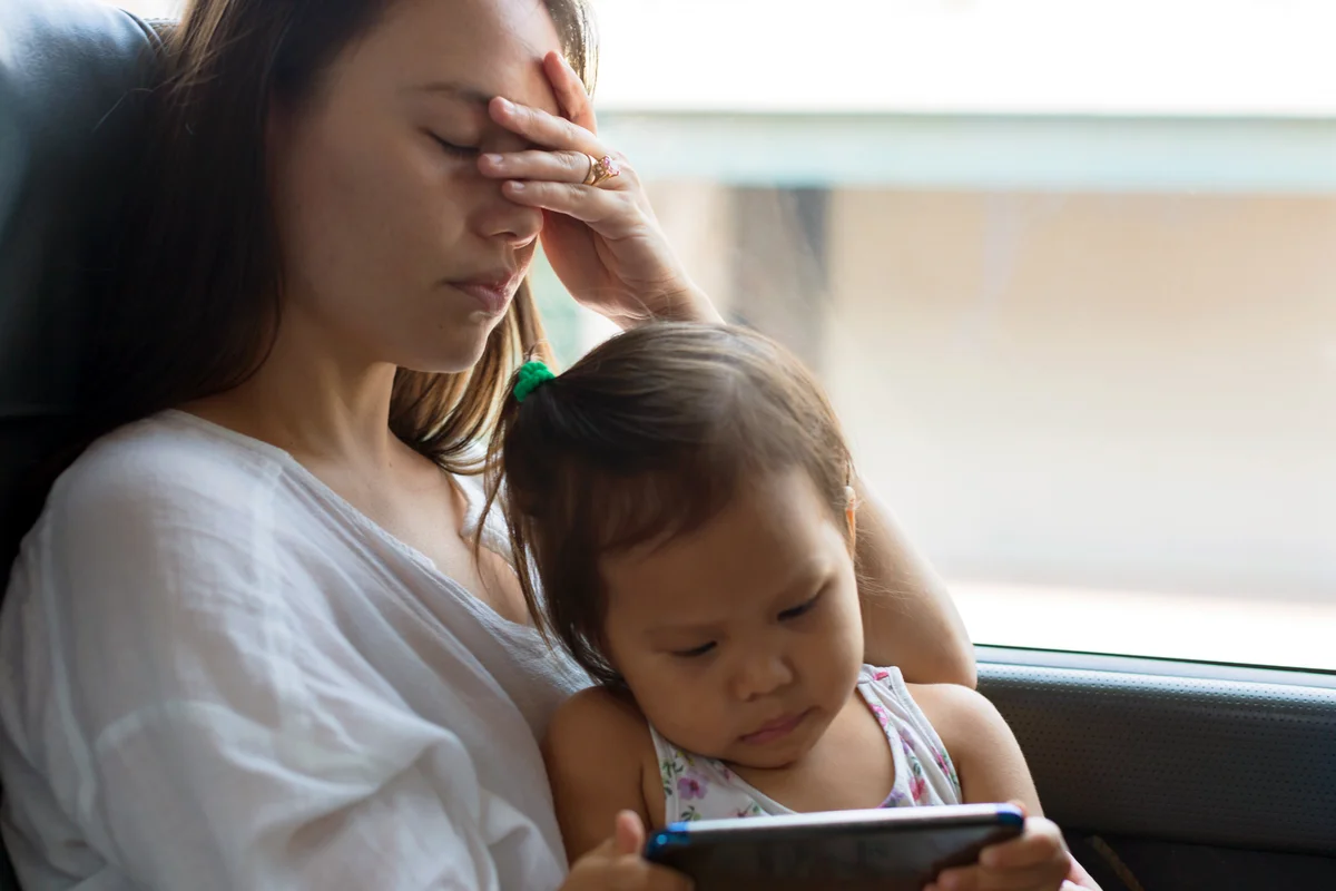 Tired stressed mother traveling with baby