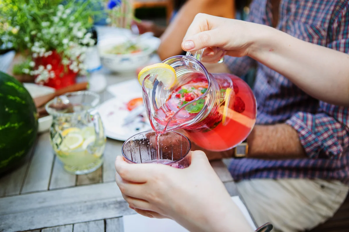 Serving french press sangria in a summer day in the garden