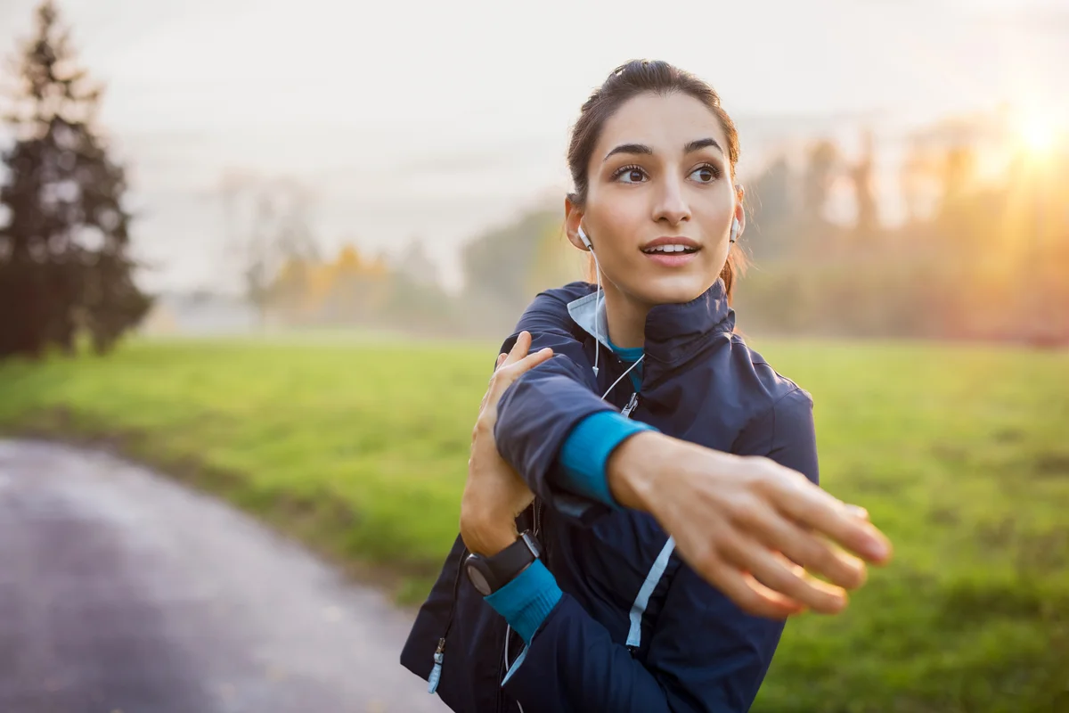 Young woman working out at sunset