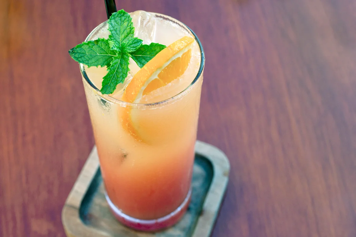 Tequila sunrise with orange garnish