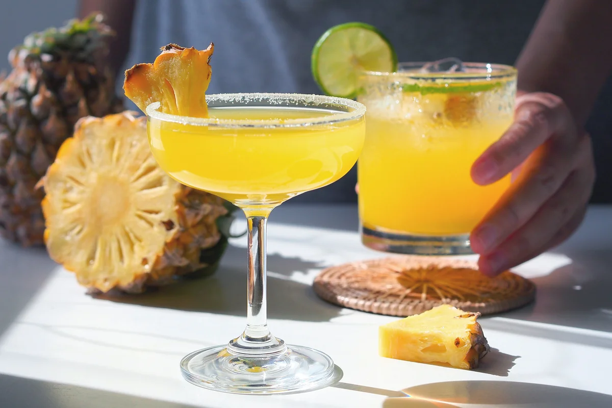 Woman preparing spicy pineapple cocktail