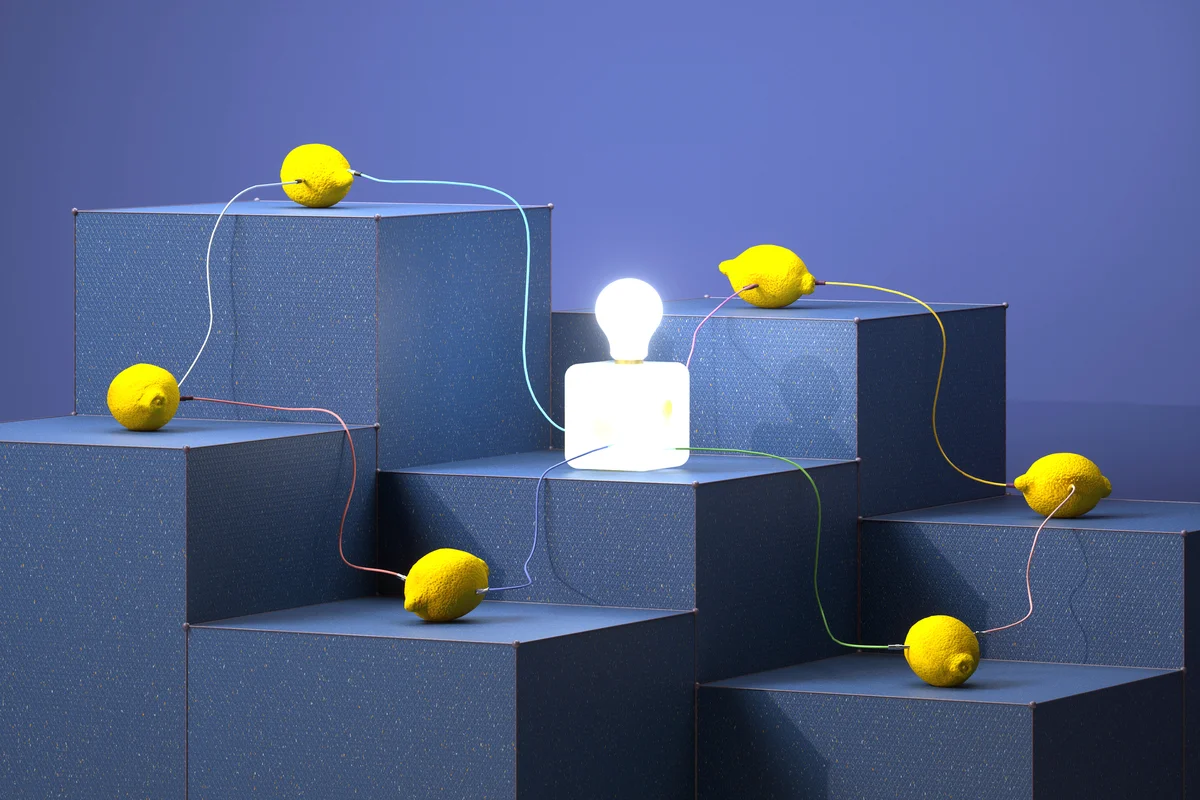Lemons on blocks connected by cables to electric lamp
