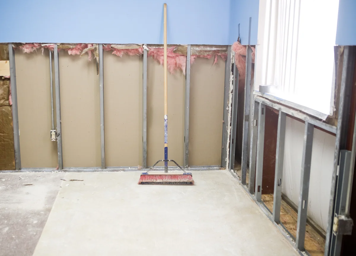 broom in a room with drywall dust