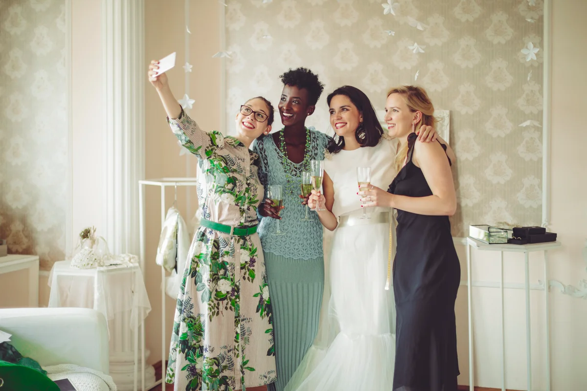friends taking a selfie with the bride at a wedding