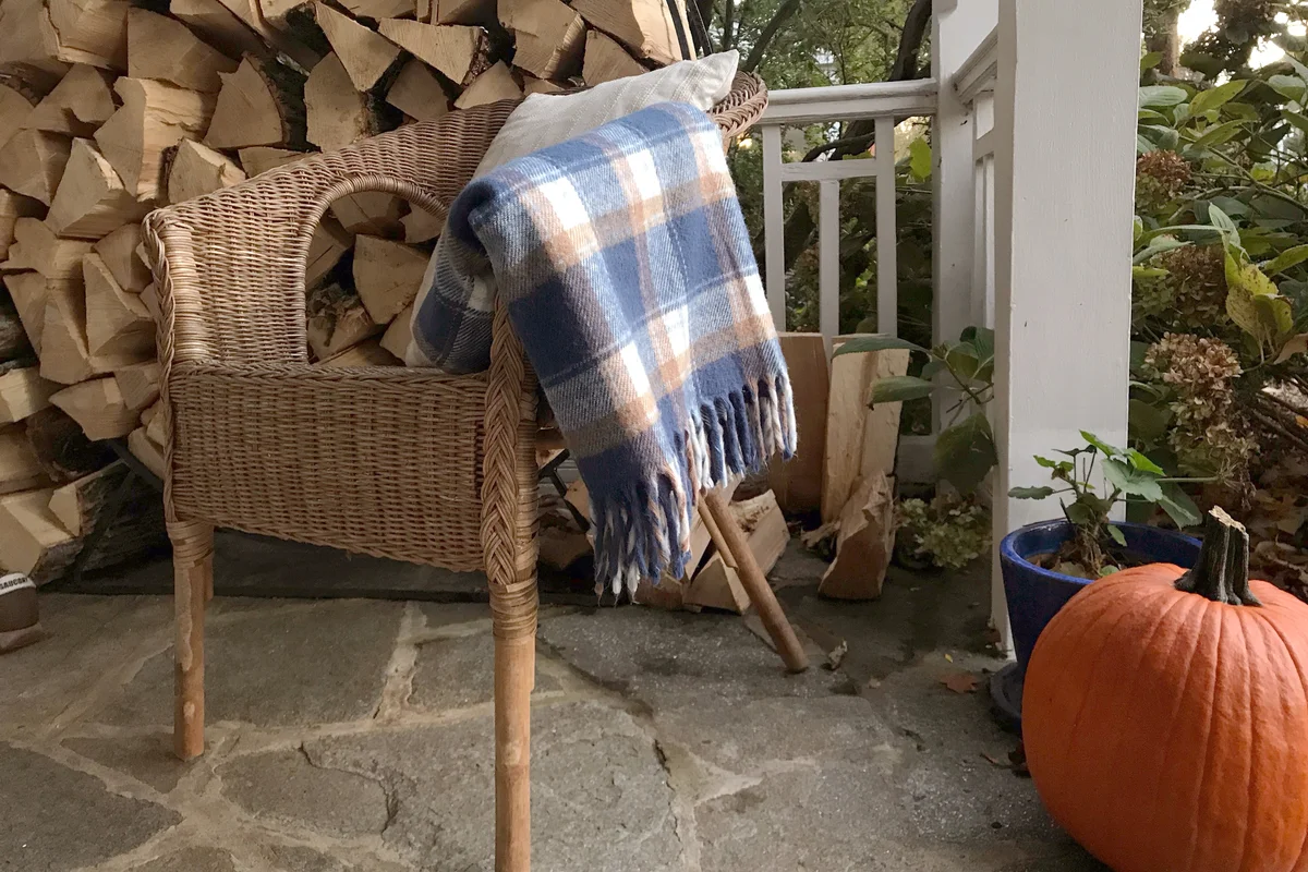 Autumn Porch Scene with Vintage Wool Blanket Draped over a Chair