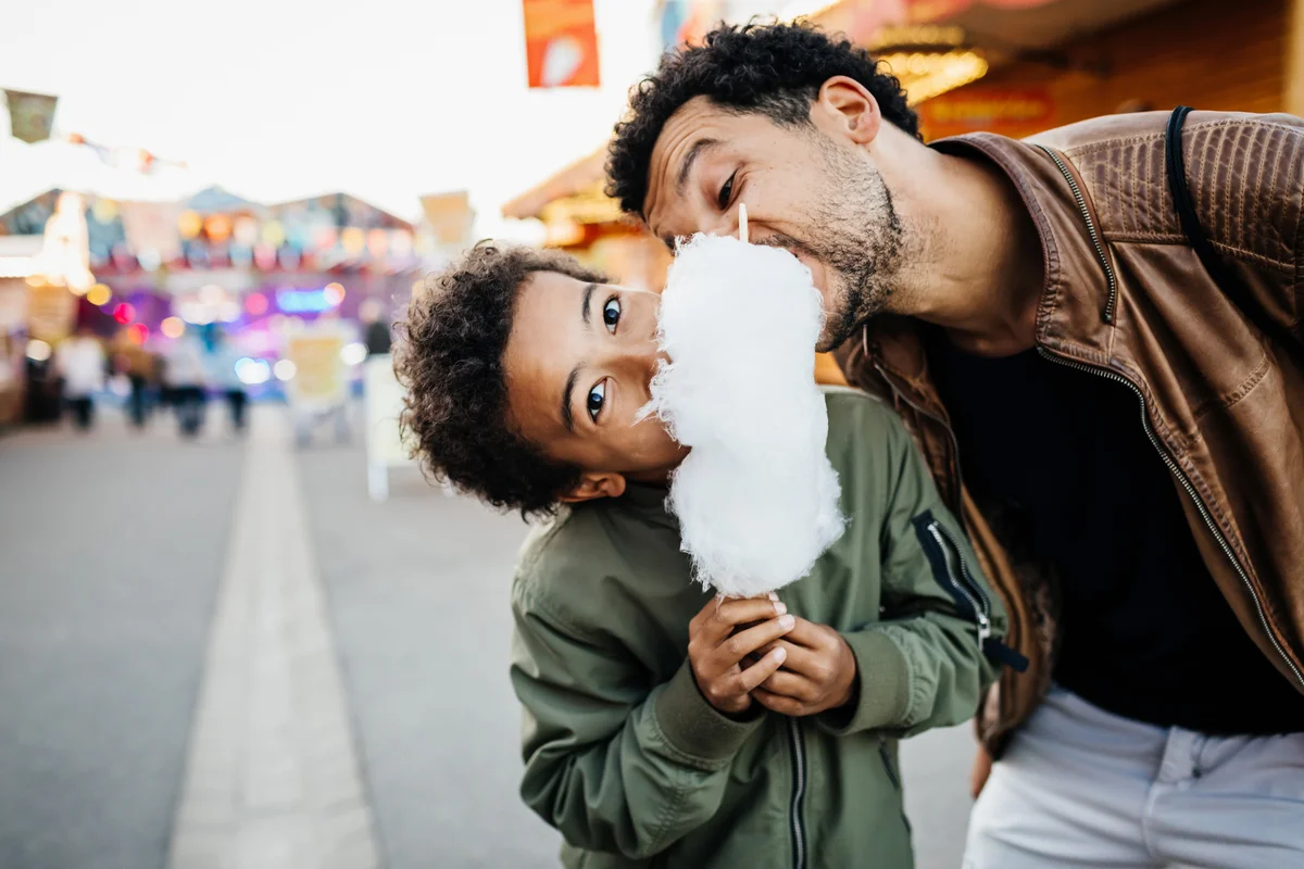 child and dad eating cotton candy