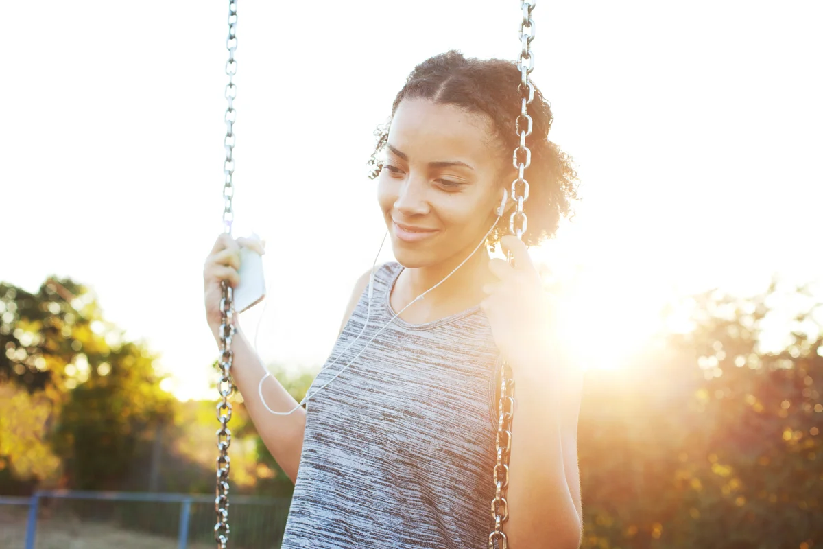 teenager swinging at playground
