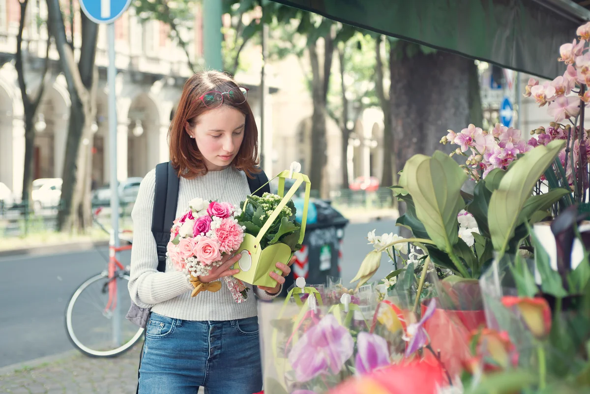teen choosing flowers