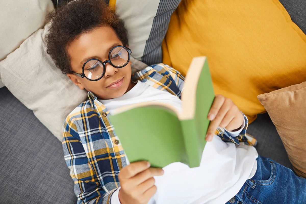 little boy reading a book