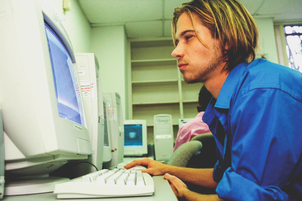Side profile of a young man working on a computer
