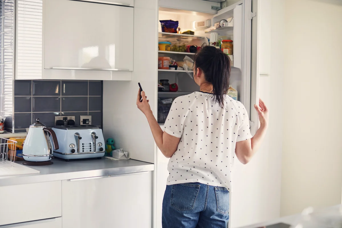 woman looking in fridge