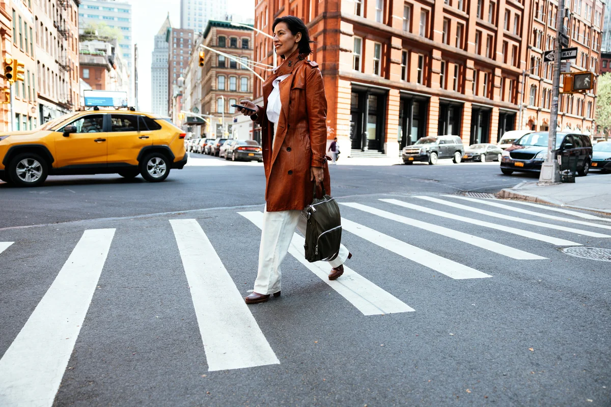 Woman walking crosswalk in busy street